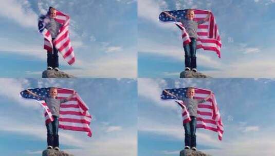 夏季美国国旗之国，金发男孩在蓝天上挥舞美国国旗高清在线视频素材下载
