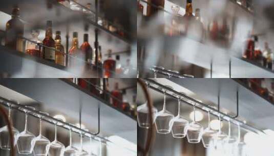 酒吧内成列的洋酒和悬挂的玻璃红酒杯高清在线视频素材下载