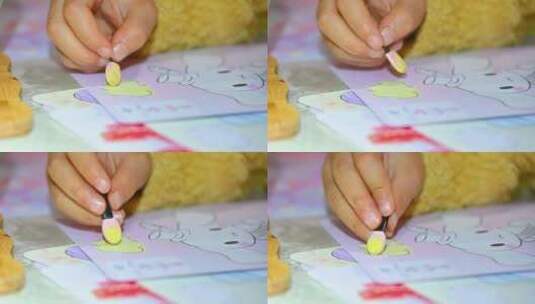 儿童拿着彩笔在绘本上涂画手特写高清在线视频素材下载