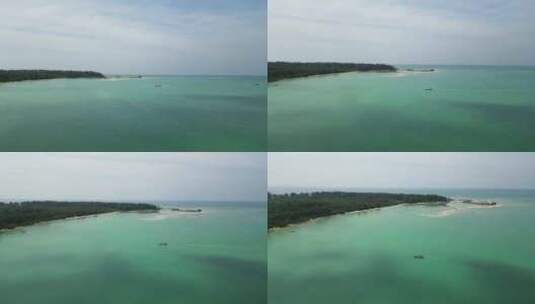 泰国龟岛的芒果湾，长尾船接近海岸，空中接高清在线视频素材下载
