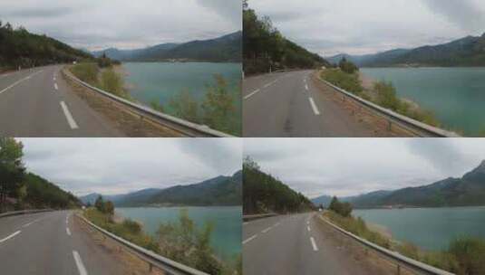 骑摩托车的人沿着靠近法国山湖的景观路骑行高清在线视频素材下载