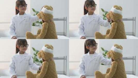 装扮成医生的小女孩给玩具小熊看病高清在线视频素材下载