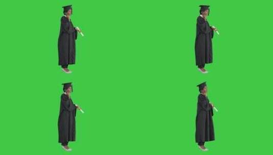 穿着毕业礼服的女学生在绿幕下打电话高清在线视频素材下载