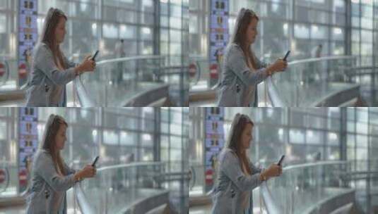 一个女人站在栏杆边上玩手机高清在线视频素材下载