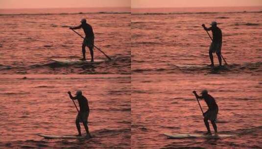 一个男人划着桨冲浪穿过泻湖高清在线视频素材下载