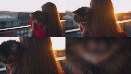 女人抱着宠物在阳台看日出高清在线视频素材下载