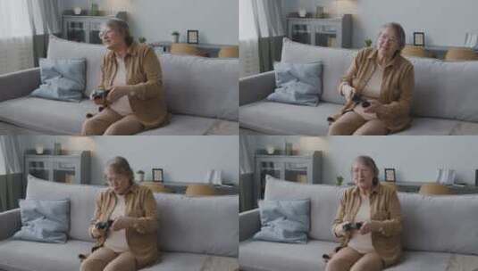 老年妇女坐在沙发上打游戏高清在线视频素材下载