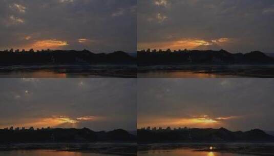 4K高清相机延时摄影城市滨江太阳穿透云层高清在线视频素材下载
