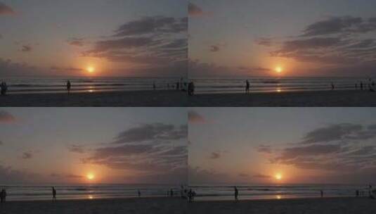 巴厘岛库塔海滩日落，人们行走剪影云天空沙和大海高清在线视频素材下载