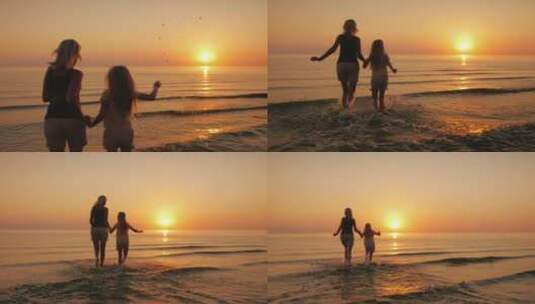 母女俩在夕阳下奔向大海高清在线视频素材下载