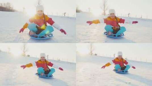 女孩坐雪盘滑下山坡高清在线视频素材下载