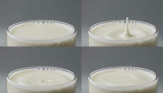 慢镜头拍摄一滴牛奶落到液面高清在线视频素材下载