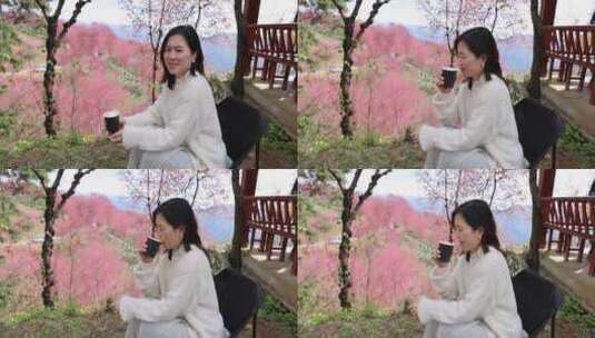 在樱花树下喝咖啡的年轻美女唯美慢镜头高清在线视频素材下载