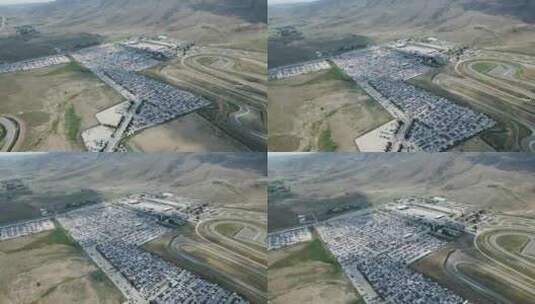 F1赛道在一个巨大停车场旁边的航拍镜头高清在线视频素材下载