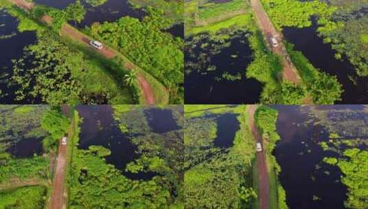 航拍汽车开在湖中心的道路上高清在线视频素材下载