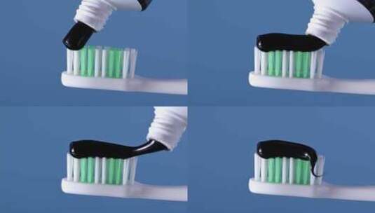蓝色背景上牙刷上的木炭牙膏。高清在线视频素材下载