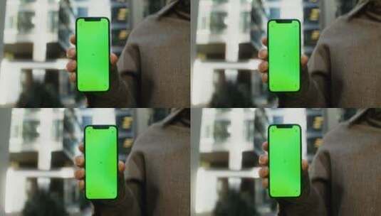 男人举着绿幕手机的特写高清在线视频素材下载