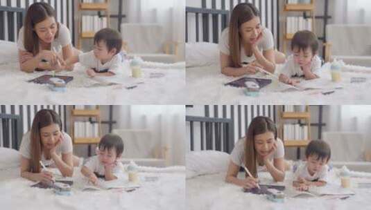 亚洲母亲和她的小男孩在床上玩高清在线视频素材下载
