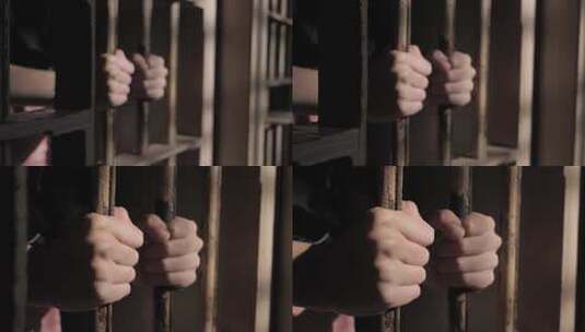 监狱中抓住铁门的手高清在线视频素材下载