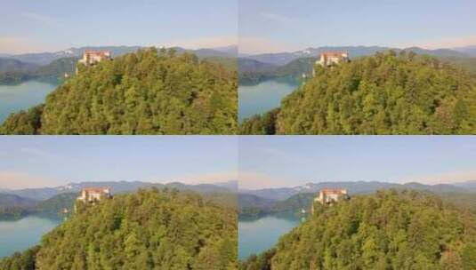 空中光滑的电影小车展示了俯瞰朱利安阿尔卑斯山布莱德湖的布莱德城堡高清在线视频素材下载