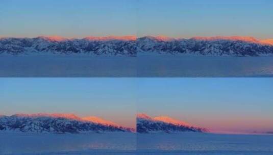 航拍新疆冬季赛里木湖日照金山雪山高清在线视频素材下载