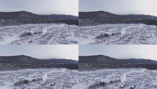 航拍新疆禾木雪景森林雪地小木屋禾木桥雪山高清在线视频素材下载