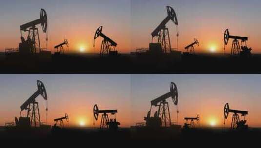 能源石油开采机磕头机在日落天空下开采石油高清在线视频素材下载