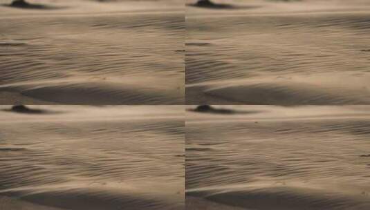 风吹过沙子波纹状的表面，带走沙粒。沙漠地区，沙尘暴高清在线视频素材下载