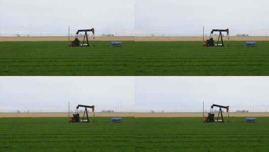 农田中央油井抽油的时间推移高清在线视频素材下载