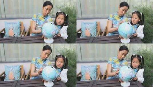 妈妈教女儿看地球仪高清在线视频素材下载
