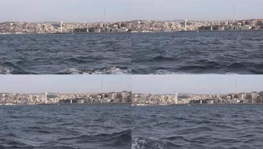 从一艘在博斯普鲁斯海峡航行的船上看到土耳其伊斯坦布尔乌斯库达的城市建筑和塔楼。-高清在线视频素材下载