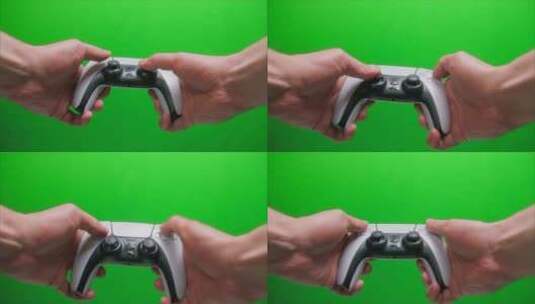 手拿着操纵杆白色游戏手柄的特写镜头在绿色背景下玩现代电子游戏高清在线视频素材下载