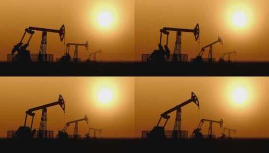 能源石油开采机磕头机在日落天空下开采石油高清在线视频素材下载