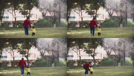 小女孩和妈妈在春天的公园玩耍牵妈妈的手高清在线视频素材下载
