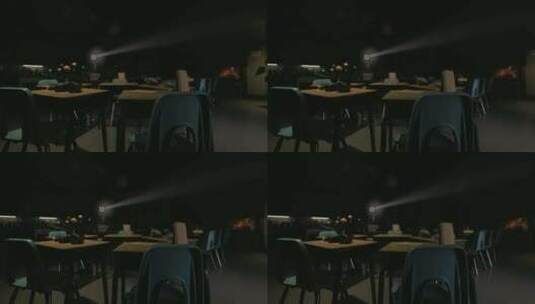一个光线昏暗的房间，有几张桌子和椅子高清在线视频素材下载