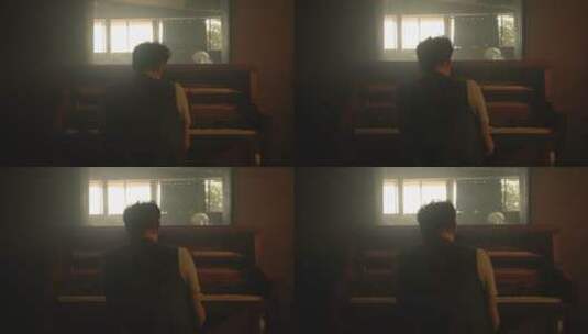 一个在弹钢琴男人的背影高清在线视频素材下载