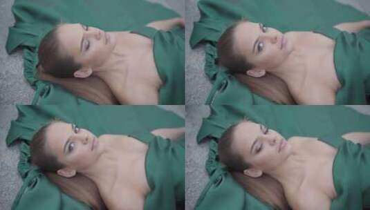 模特穿着绿色晚礼服躺在地上高清在线视频素材下载