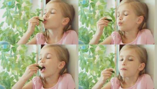 女孩坐在窗台上吃黄瓜高清在线视频素材下载