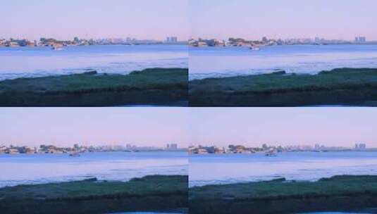 鸭绿江岸边朝鲜小镇与一艘航行江面的游船高清在线视频素材下载