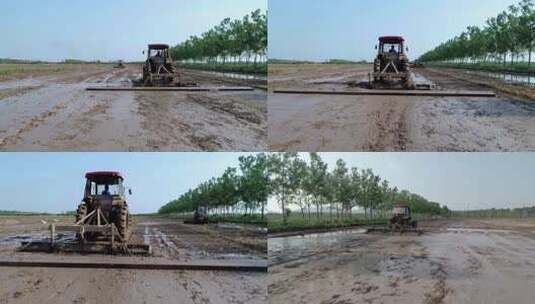 航拍拖拉机在稻田平整土地高清在线视频素材下载