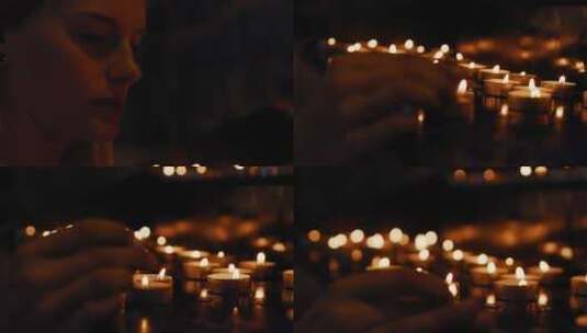 女人在昏暗的房间里用其他蜡烛点燃茶灯高清在线视频素材下载