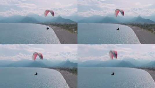 人乘着降落伞在海洋上空滑翔高清在线视频素材下载