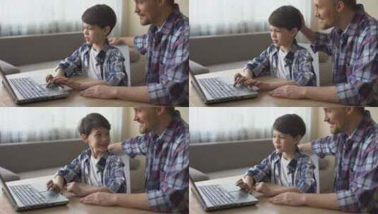 父亲和儿子在电脑上进行网购高清在线视频素材下载