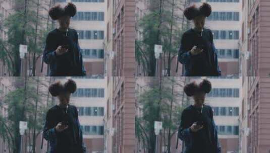女孩站在街头玩手机高清在线视频素材下载