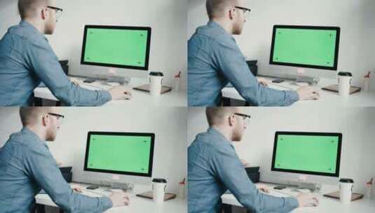 在最小的办公室里操作绿屏显示器的人高清在线视频素材下载