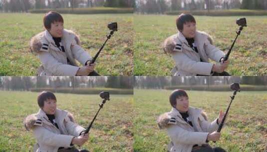 冬季坐在草坪上自拍的中国女性高清在线视频素材下载