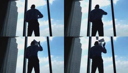 站在落地窗前的男人扔纸高清在线视频素材下载