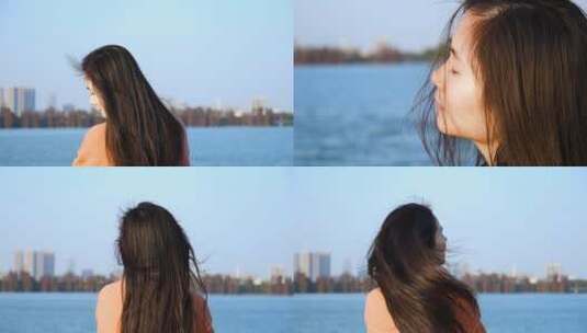 女孩在江边吹风，风吹发丝飞舞视频素材高清在线视频素材下载
