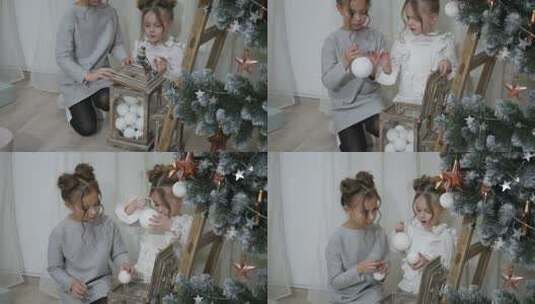 两个小女孩在圣诞树下玩耍高清在线视频素材下载