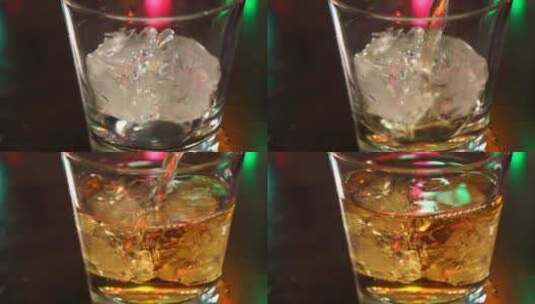 威士忌倒在有冰块杯里高清在线视频素材下载